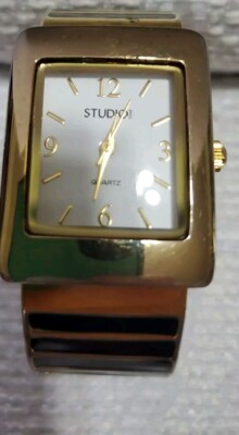 Studio! Ladies Black And Gold Cuff Watch With Square Face And Goldtone Bezel -image